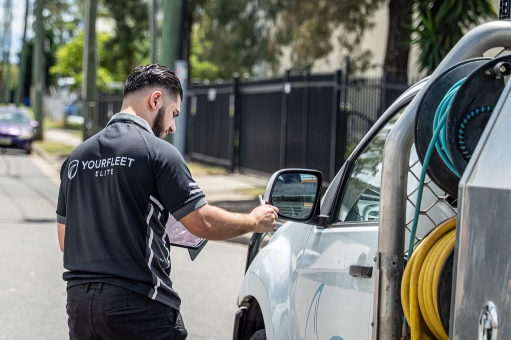 Fleet walkaround inspection of a service ute with a tablet checklist
